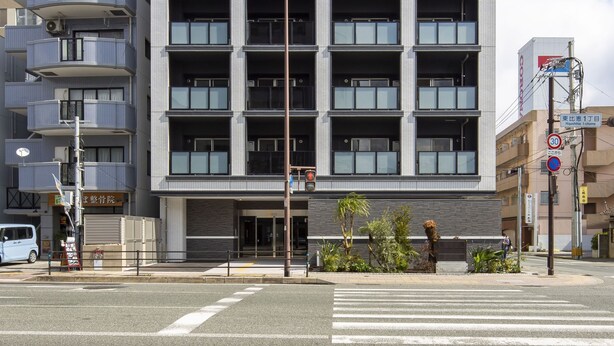 A modern multi-story building with a uniform facade, balconies, and a ground-level entrance. - SG Residence Inn Hakata (Fukuoka)