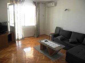 Apartment, Multiple Beds | Living room | TV