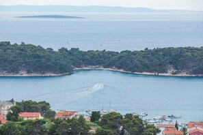 A coastal town with a marina, boats, and a clear view of the sea.