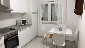 Apartment, Multiple Beds | Private kitchen | Oven, stovetop, cookware/dishes/utensils