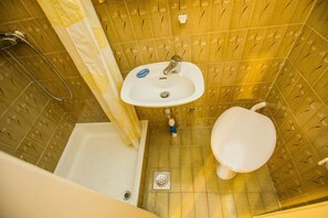 A bathroom with a bathtub, sink, and toilet.