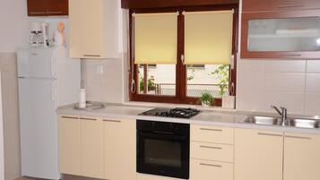 Apartment, Multiple Beds | Private kitchen | Fridge, oven, stovetop, coffee/tea maker