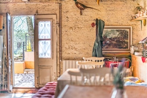 A rustic room with a large window, a door leading outside, and a painting on the wall. - Holiday House Valter (Rasa)