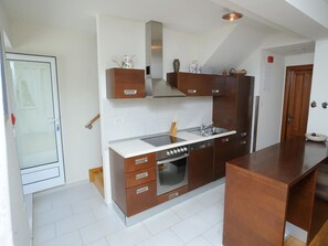 Apartment, Multiple Beds | Private kitchen | Stovetop, dishwasher, coffee/tea maker, cookware/dishes/utensils