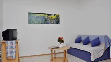 Apartment, Multiple Beds | Living room | TV