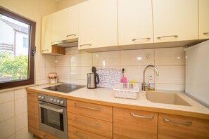 Apartment, Multiple Beds | Private kitchen | Stovetop, cookware/dishes/utensils - Apartments Protega (Okrug)