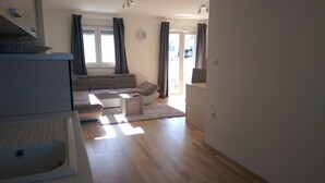 Un salon avec un canapé, une table basse et une vue sur l’extérieur.