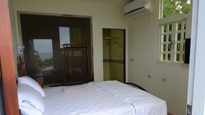 A single bed with a white mattress and pillows, a wooden chair, a sliding glass door, and an air conditioning unit. - The Song of Eagle (Donghe)