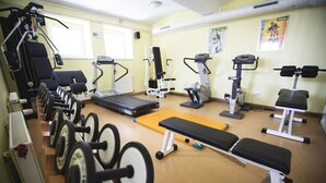 A gym with various exercise equipment including treadmills, weight machines, and free weights. - Hotel Tisa (Hoce-Slivnica)