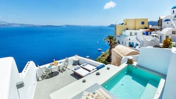 Enjoy breathtaking views of the Aegean Sea from this luxurious rooftop terrace, featuring a pool and comfortable outdoor seating.