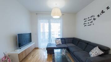 Deluxe Apartment, 1 Bedroom, Balcony | Living area | Flat-screen TV