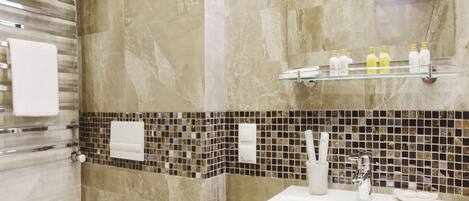 A modern bathroom with a toilet, sink, and towel rack.