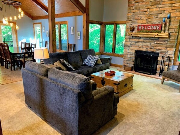 A cozy living room with a fireplace, a sofa, and a coffee table.
