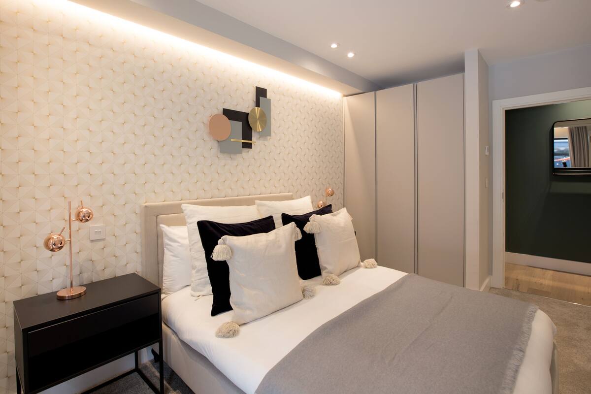 Premium bedding, desk, laptop workspace, blackout drapes