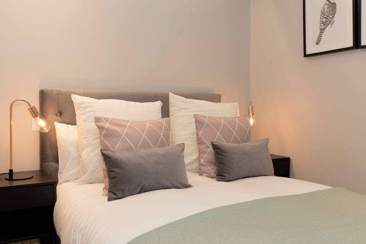 Studio | Premium bedding, desk, laptop workspace, blackout drapes