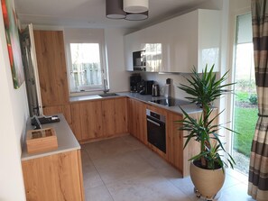 Enjoy cooking in this well-lit kitchen with a large island and modern appliances.