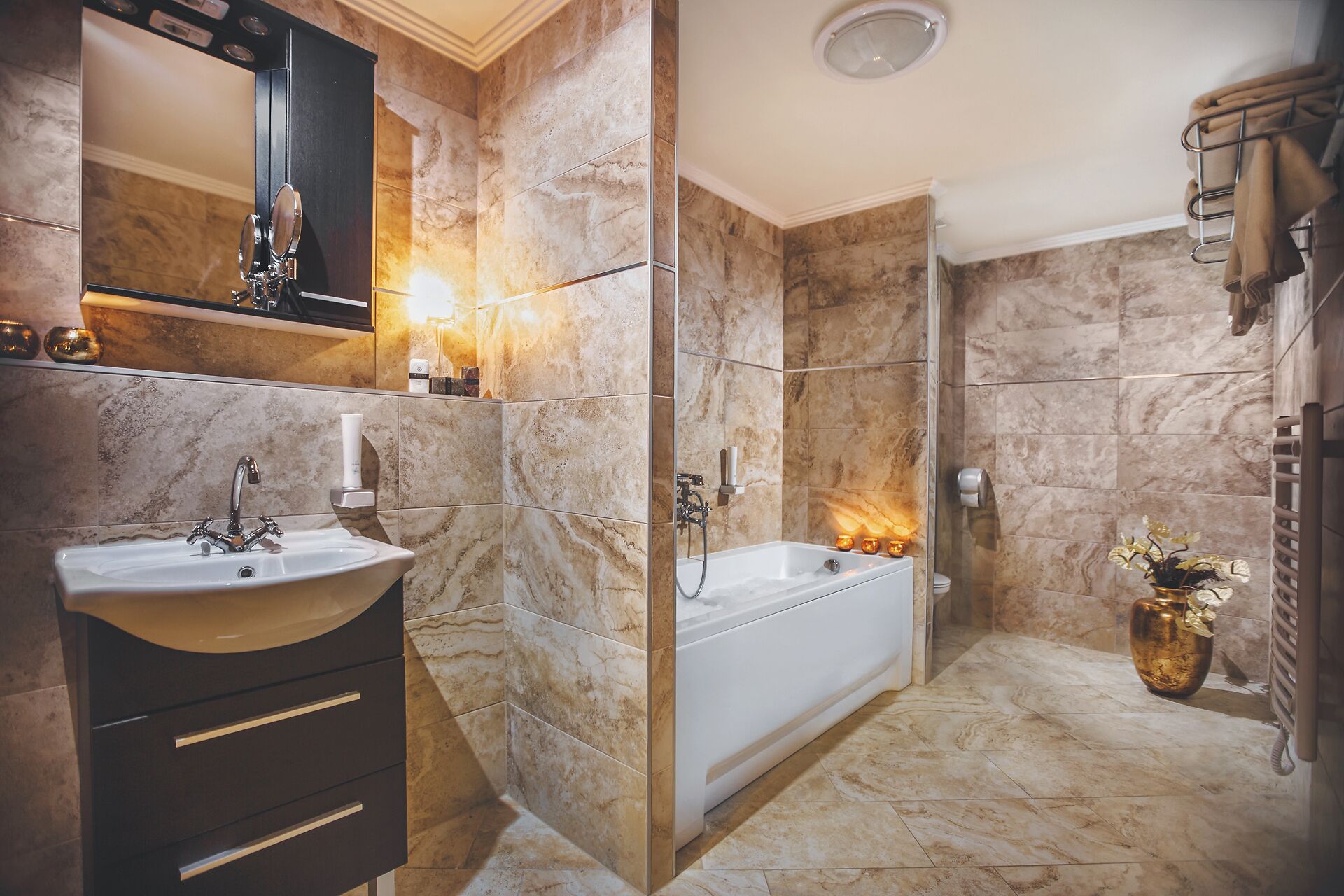 A modern bathroom with a freestanding bathtub, a vanity with a sink, and a large mirror.