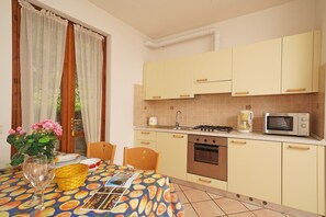 Enjoy cooking in this well-equipped kitchen with a stove, microwave, and sink.