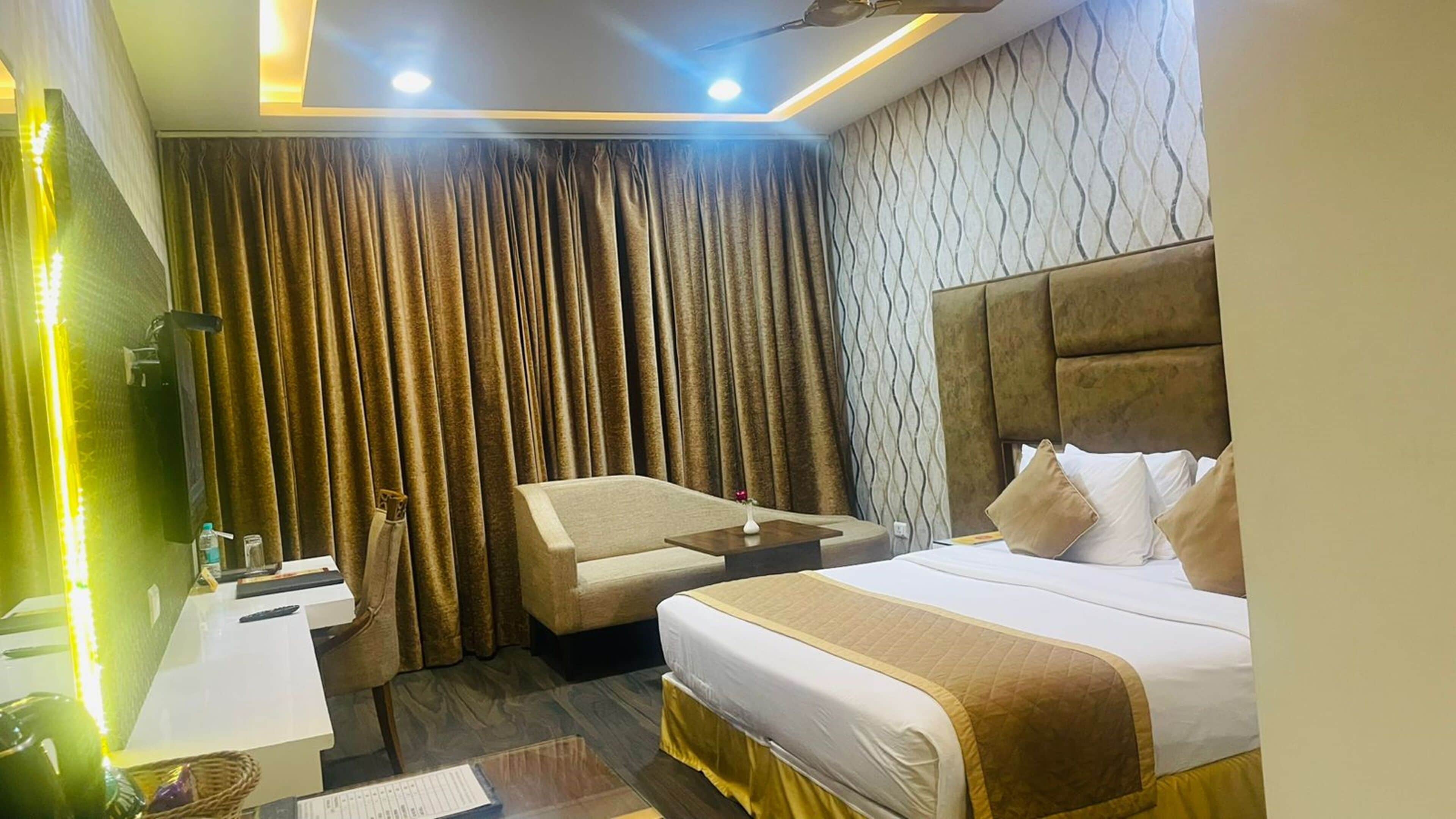 A hotel room with two beds, a desk, a chair, and a vanity with a mirror.