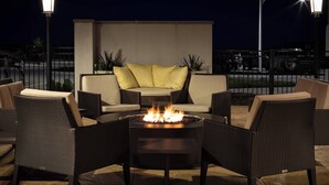 An outdoor seating area with a fire pit, lounge chairs, and a sofa. - Residence Inn by Marriott Des Moines Ankeny (Ankeny)