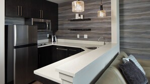 A modern kitchen with stainless steel appliances, a white countertop, and a built-in sink. - Residence Inn by Marriott Des Moines Ankeny (Ankeny)