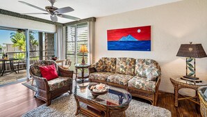 A living room with a sofa, chairs, a coffee table, and a painting on the wall. - 🏖️Beautiful Ocean Views | Top Floor | Concierge Included (Kailua Kona)