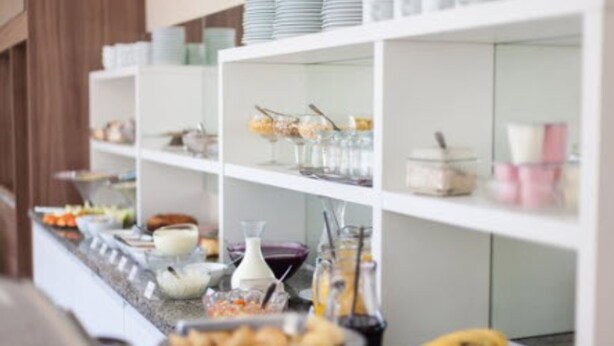 A buffet setup with various food items and beverages.