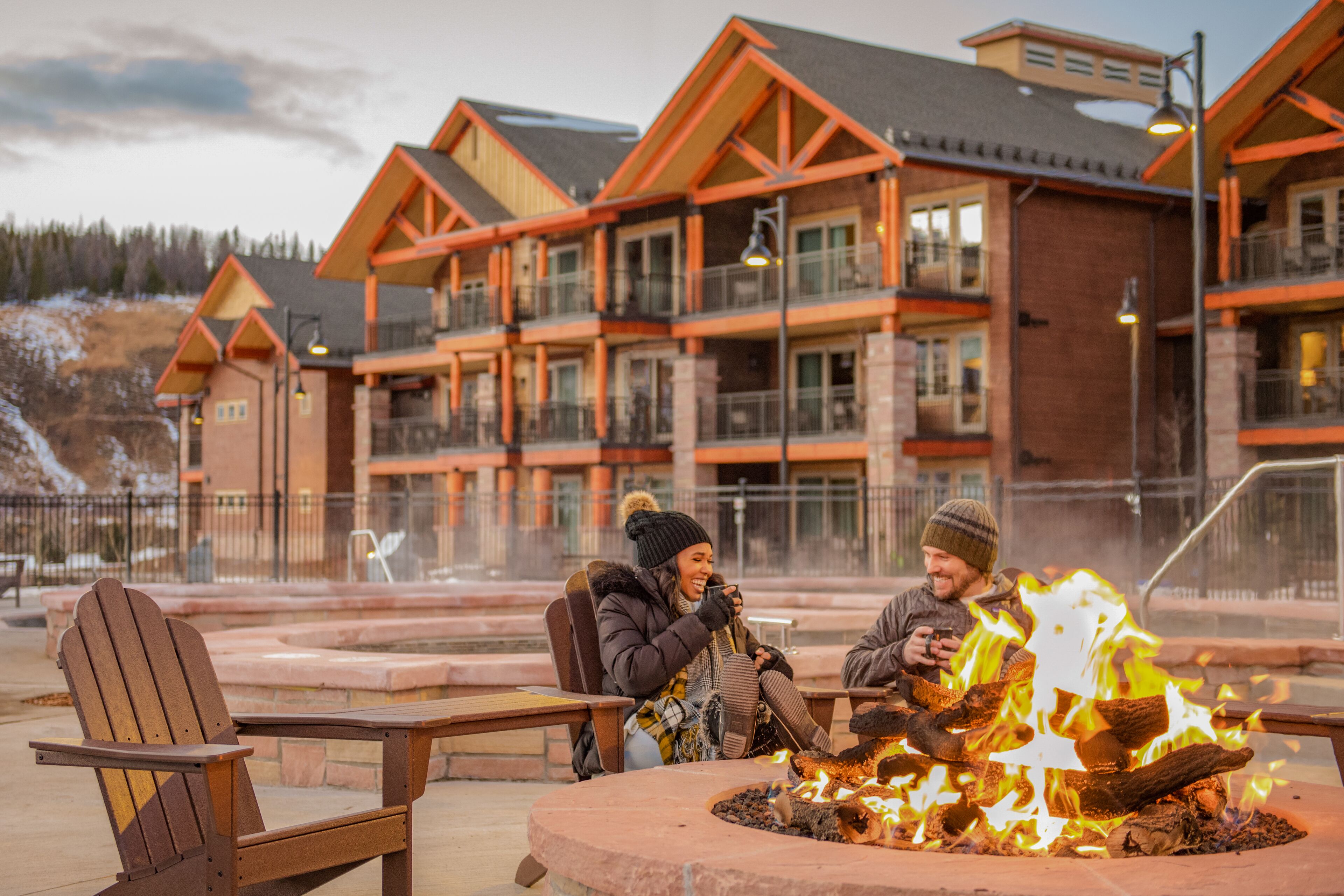 A lodge with a fire pit and outdoor seating.