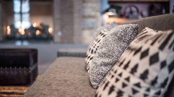 A cozy living room with a sofa and patterned cushions.