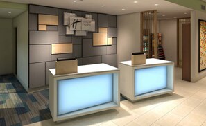 A reception area with two reception desks, a wall-mounted clock, and a Holiday Inn Express sign. - Holiday Inn Express & Suites Auburn Downtown by IHG (Auburn)