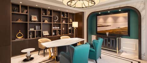 A modern interior with a dining area, teal chairs, a marble floor, and a large painting on the wall.