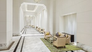 A spacious hotel lobby with a long corridor, seating area, and a chandelier. - ITC Royal Bengal, a Luxury Collection Hotel, Kolkata (Kolkata)