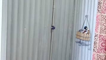 A corrugated metal wall with a wooden beam structure at the top.