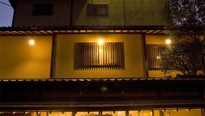 A traditional Japanese building with a sign indicating it is a hotel. - Kosenkaku Yoshinoya (Totsukawa)