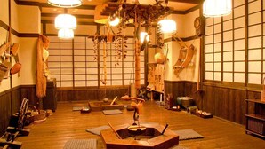 A traditional Japanese room with tatami mats, wooden furniture, and hanging decorations. - Kosenkaku Yoshinoya (Totsukawa)