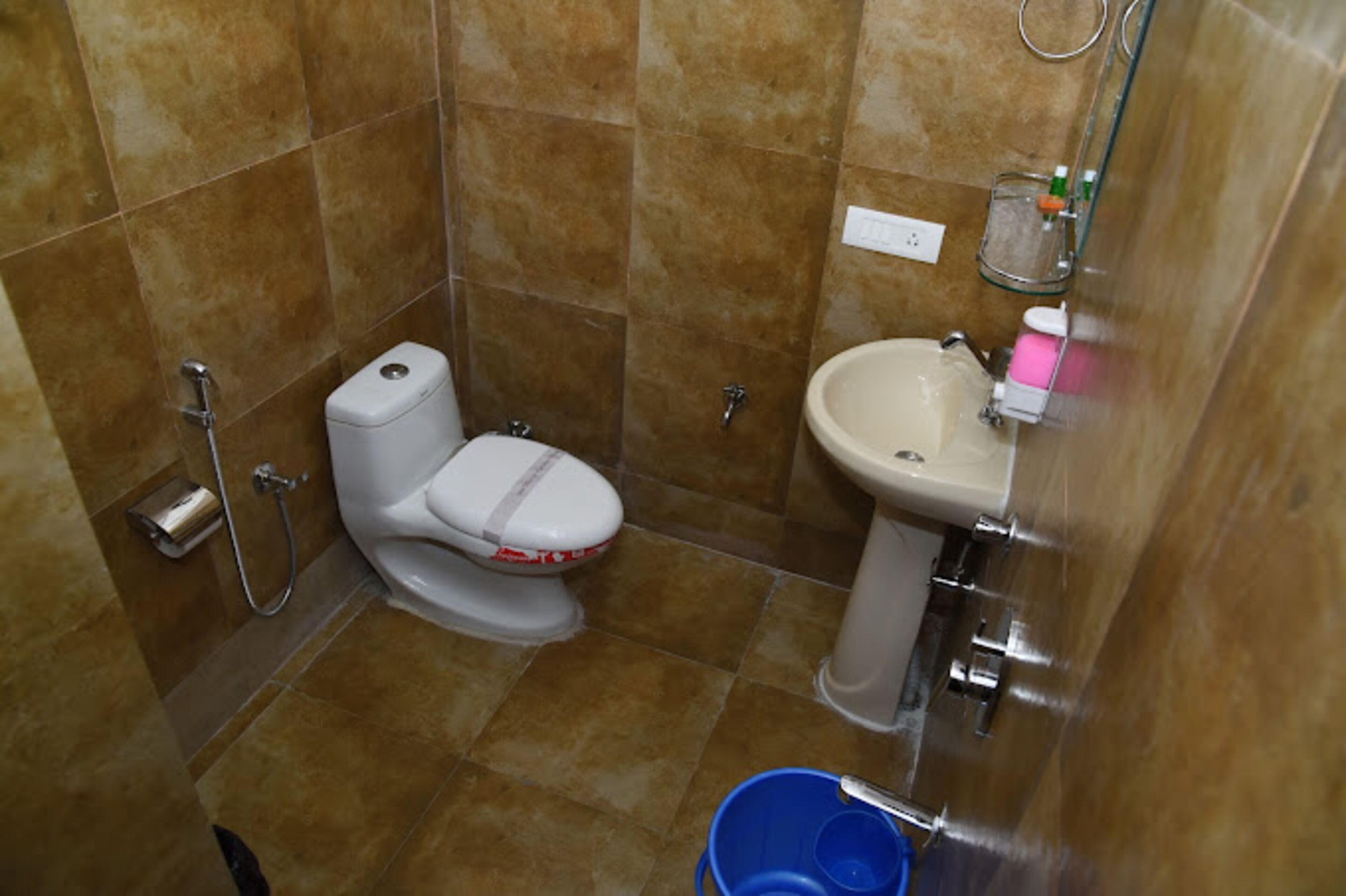 A bathroom with a toilet, sink, and shower.