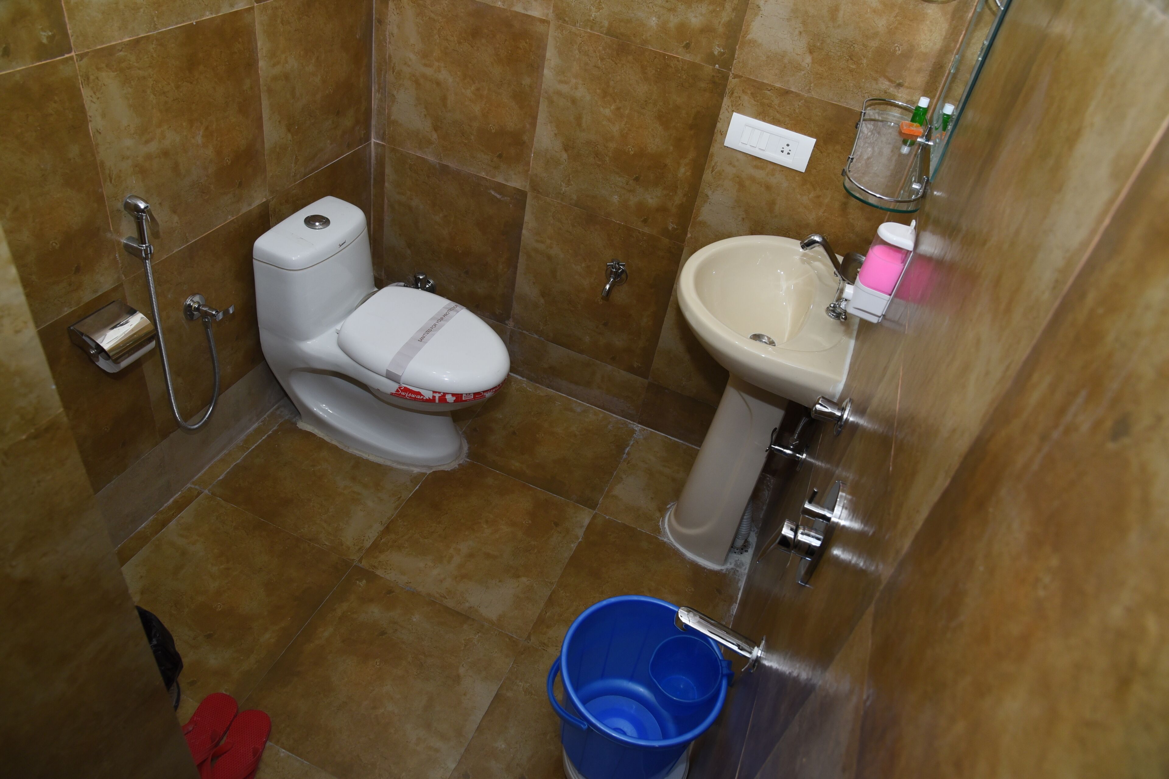 A bathroom with a toilet, sink, and shower.