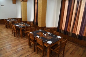 Guests can dine in comfort at this elegant space, surrounded by a long table and comfortable chairs.