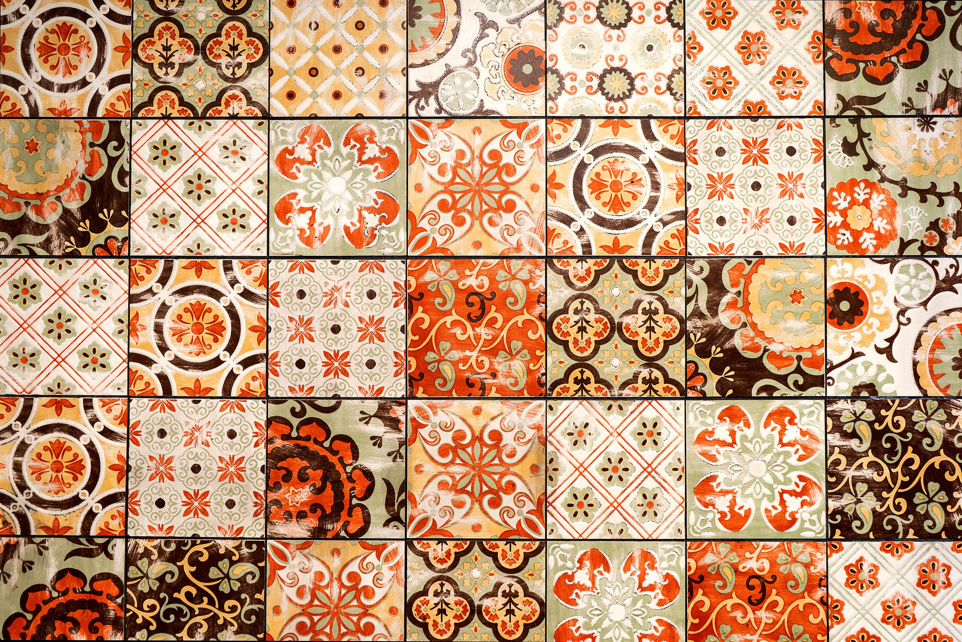 A wall of variously patterned tiles.