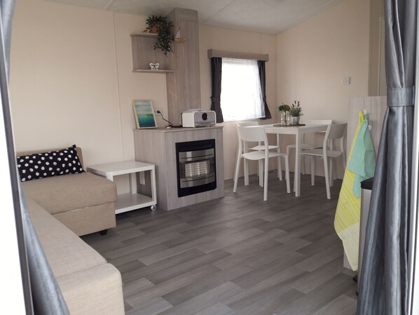 A compact living space with a kitchenette, a dining area, and a seating area.