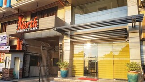 A building with a sign for 'North Tourist Inn' and a gated entrance. - North Tourist Inn (Bacolod)