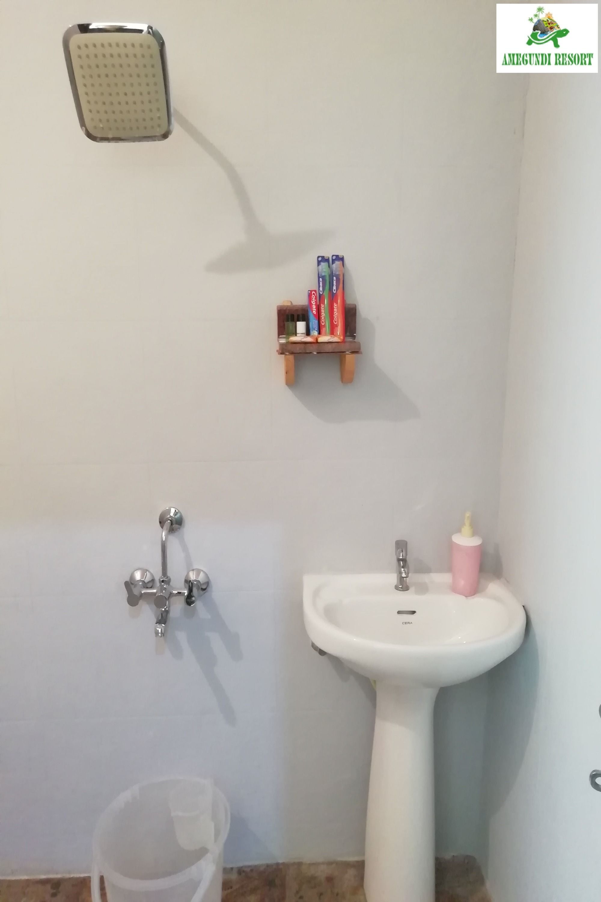 A bathroom with a shower, a sink, and a small shelf with toiletries.