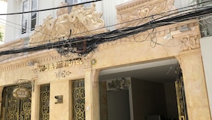 A hotel entrance with ornate gold doors and a sign indicating "HOTEL YOU & ME." - hotel you and me (Ho Chi Minh City)