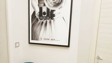 Fotografia in bianco e nero incorniciata che ritrae una persona con una macchina fotografica, con la scritta “I love art…” sottostante.