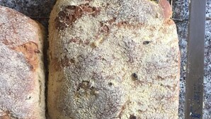 Two loaves of bread on a cooling rack with a knife beside them. - Banshan Greatwall Mountain View Resort (Huairou)