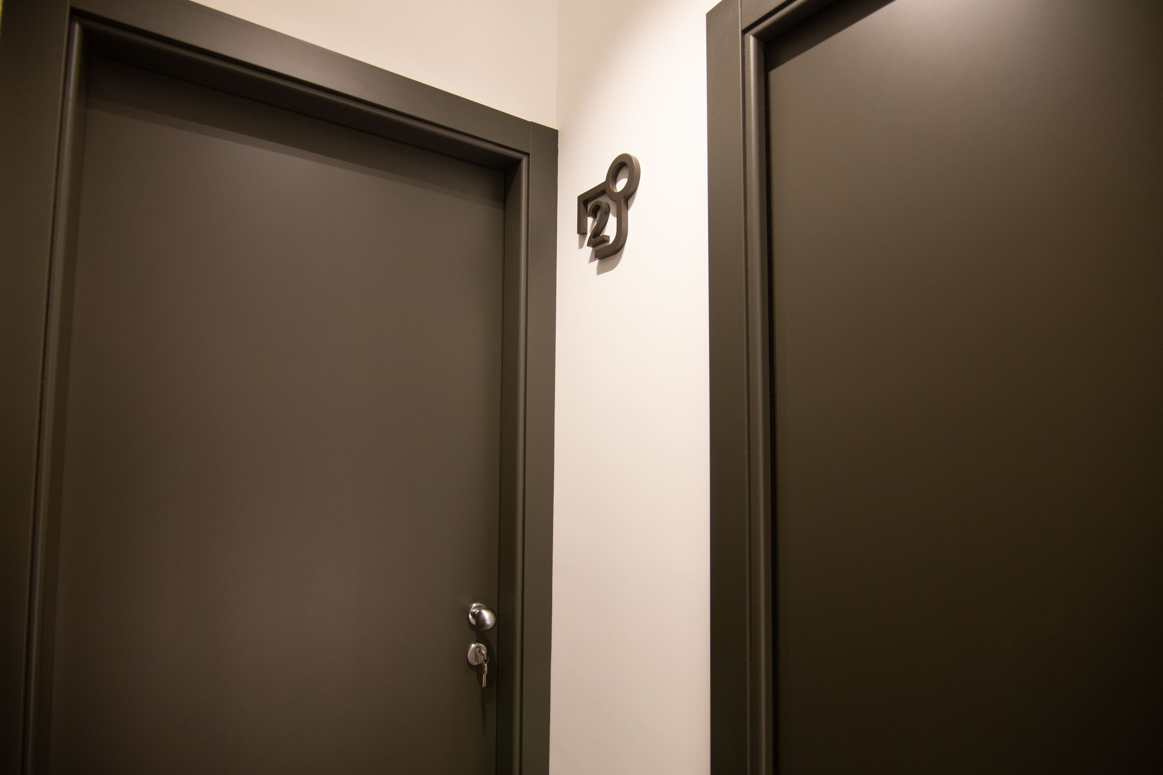 A closed door with a keyhole and a doorbell.