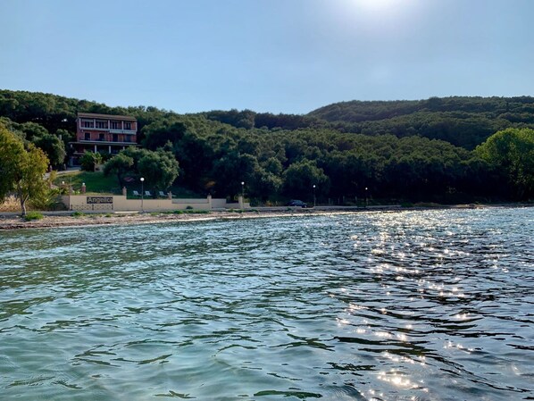 A waterfront property with a building labeled "Angelica," a river, and a forested hillside.