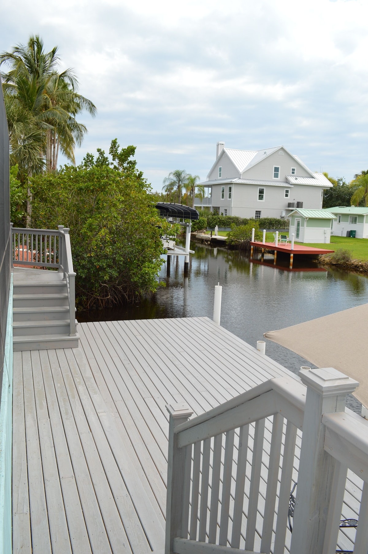 Photo 4 of Adorable canal front cottage close to beach with boat ramp, dock & heated pool.