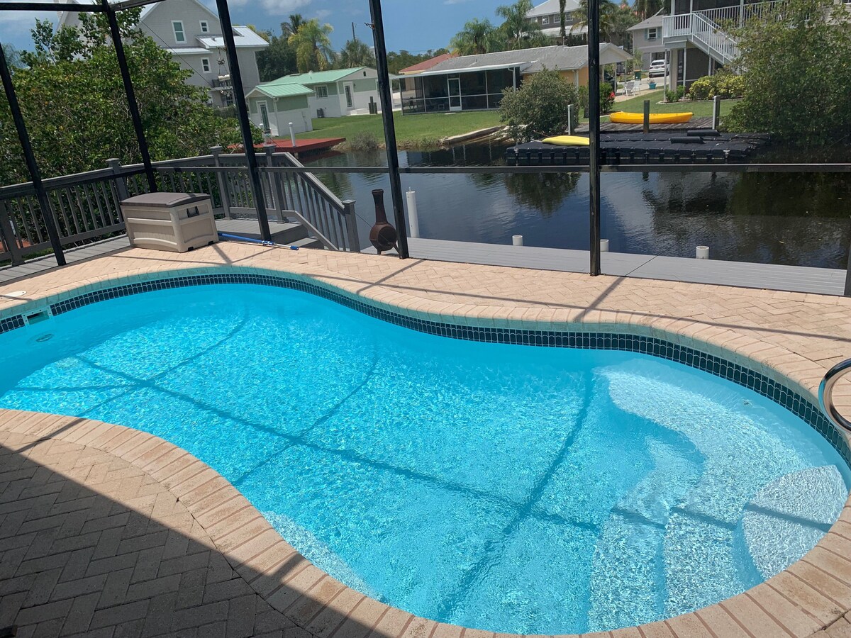 Photo 5 of Adorable canal front cottage close to beach with boat ramp, dock & heated pool.
