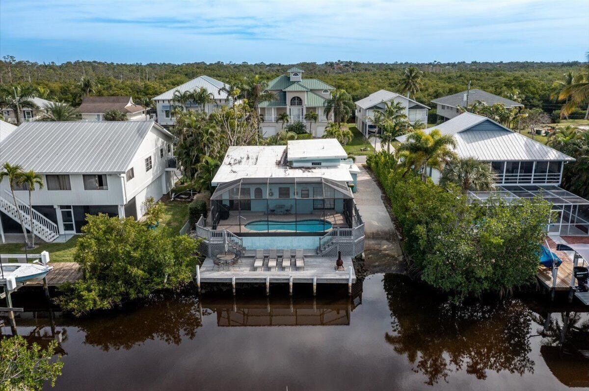 Photo 30 of Adorable canal front cottage close to beach with boat ramp, dock & heated pool.